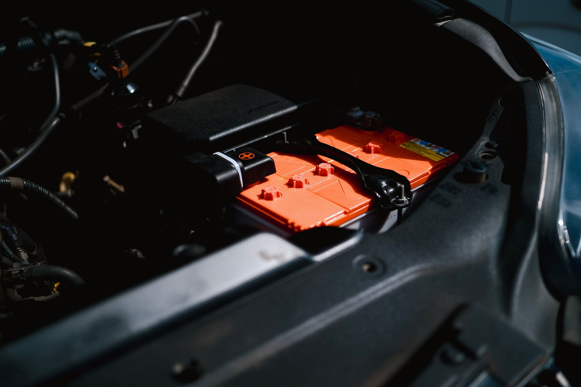 Detailed view of an electric car battery inside a vehicle's engine compartment, highlighting sustainable technology.